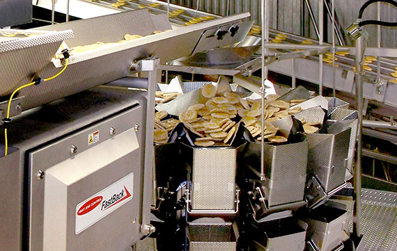 Conveying sausage patties to multihead weigher scales