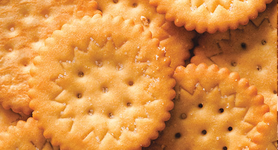 Oil spray and salt application on crackers and other foods
