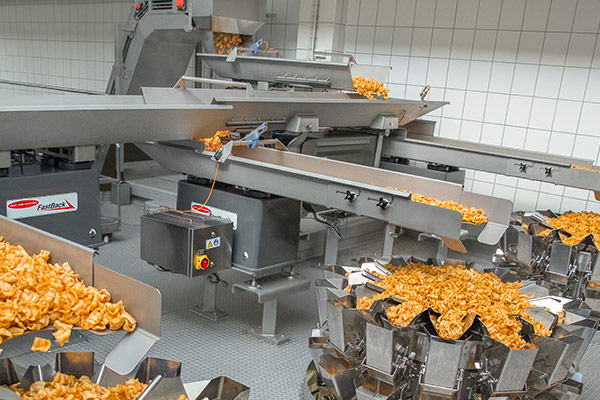 Conveying snack food to packaging equipment