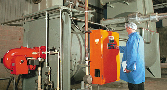 Man operating Heat and Control's KleenHeat Heat Exchanger