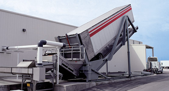 Unloading potatoes from truck to transfer equipment