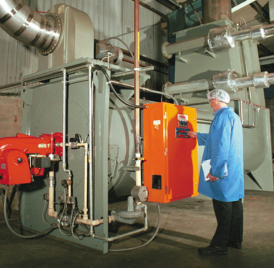 Man operating Heat and Control's KleenHeat Heat Exchanger