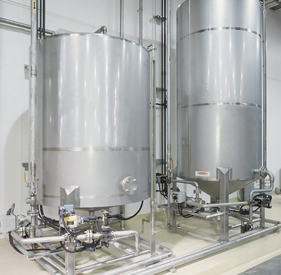 Oil holding tanks for continuous and batch fryer systems