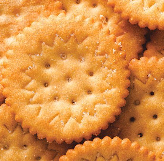 Oil spray and salt application on crackers and other foods