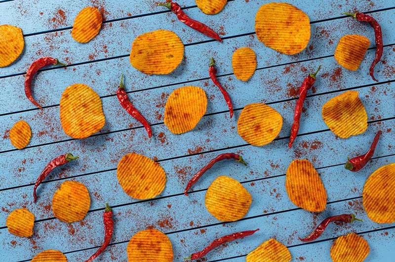 Sistemas de aplicación de sazonado en snacks