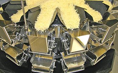 Combination weighing of shredded cheese