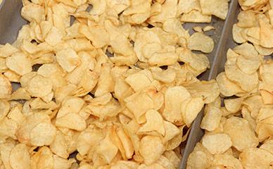 Continuous kettle cooked hard-bite potato chips