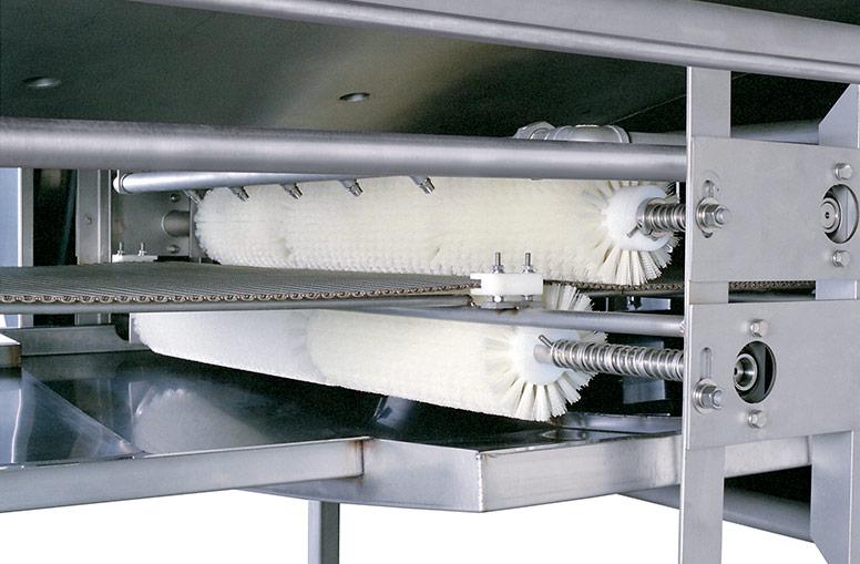 Clean-in-place sprays and continuous conveyor belt cleaning system